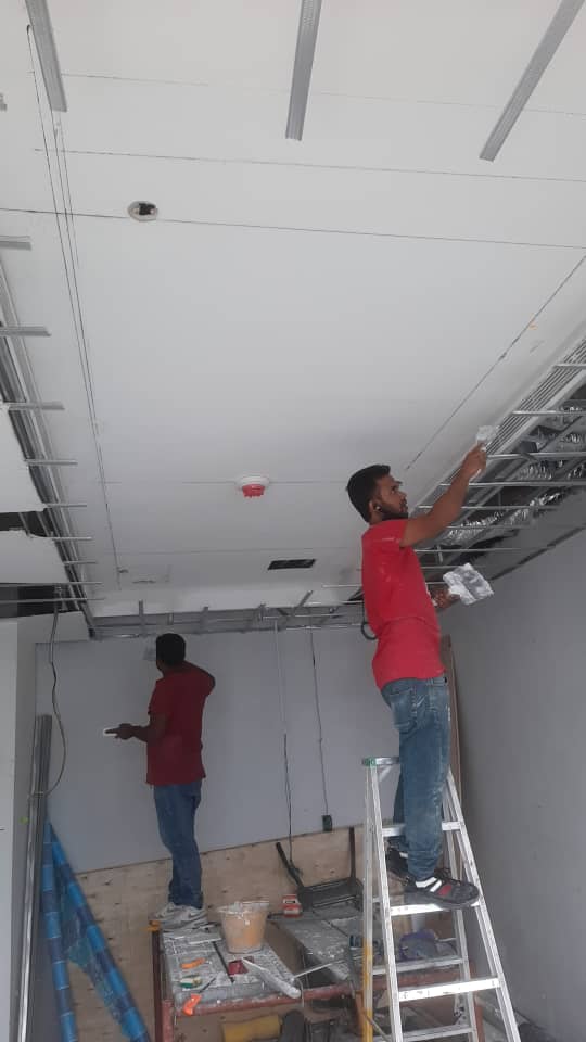 Professional painting on a wall with roller